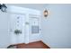 Condo entrance with carpeted floor, overhead lighting, and an decorated front door at 1655 S Highland Ave # B118, Clearwater, FL 33756