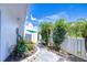 Condo exterior featuring tropical plants, private entrance, and blue umbrella at 1655 S Highland Ave # B118, Clearwater, FL 33756