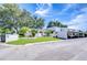 Exterior shot of building with lush landscaping and covered parking in a sunny neighborhood at 1655 S Highland Ave # B118, Clearwater, FL 33756
