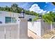Well-maintained condo exterior with decorative outdoor lighting and white picket fence at 1655 S Highland Ave # B118, Clearwater, FL 33756