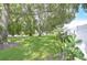 Well-maintained front yard with lush green grass and mature trees providing shade at 1655 S Highland Ave # B118, Clearwater, FL 33756