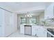 Bright kitchen featuring stainless steel appliances, white cabinets, and a tile backsplash at 1655 S Highland Ave # B118, Clearwater, FL 33756