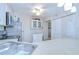 Bright kitchen featuring stainless steel appliances, white cabinets, and a ceiling fan at 1655 S Highland Ave # B118, Clearwater, FL 33756