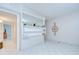 Bright living room with tile floors, decorative shelving, and neutral paint at 1655 S Highland Ave # B118, Clearwater, FL 33756