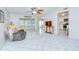 Bright living room featuring tile floors, a ceiling fan, and open access to other rooms at 1655 S Highland Ave # B118, Clearwater, FL 33756