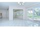 Bright living room featuring tile floors and sliding glass doors to the backyard at 1655 S Highland Ave # B118, Clearwater, FL 33756