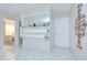 Bright living room with tile floors, decorative shelving, and neutral paint at 1655 S Highland Ave # B118, Clearwater, FL 33756