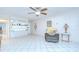 Comfortable living room featuring tile flooring, a ceiling fan, and neutral decor at 1655 S Highland Ave # B118, Clearwater, FL 33756