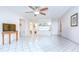 Spacious living area with bright tile floors, a ceiling fan, and open floor plan at 1655 S Highland Ave # B118, Clearwater, FL 33756