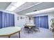 Community room features card tables and chairs with blue curtains at 1655 S Highland Ave # B118, Clearwater, FL 33756