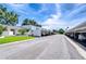 View of long covered parking with residences nearby and well maintained street at 1655 S Highland Ave # B118, Clearwater, FL 33756