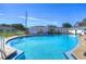 Exterior view of sparkling blue pool and community buildings in a sunny setting at 1655 S Highland Ave # B118, Clearwater, FL 33756