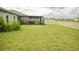 Spacious backyard featuring a screened-in lanai and a white vinyl fence at 16623 Carlton Pond St, Wimauma, FL 33598