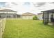 A spacious backyard with a screened-in porch and well-maintained fence at 16623 Carlton Pond St, Wimauma, FL 33598