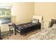 Cozy bedroom with twin beds, a desk, and a bright window at 16623 Carlton Pond St, Wimauma, FL 33598