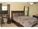 Spacious bedroom featuring a comfortable bed and bright windows at 16623 Carlton Pond St, Wimauma, FL 33598