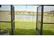 A screened-in patio showing views of a pond and backyard at 16623 Carlton Pond St, Wimauma, FL 33598
