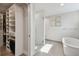 Bright bathroom featuring a glass shower, soaking tub, and walk-in closet at 199 Dali Blvd # 607, St Petersburg, FL 33701
