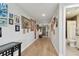 Wide hallway featuring hardwood floors and walls adorned with artwork at 199 Dali Blvd # 607, St Petersburg, FL 33701