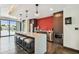 Common kitchen features a waterfall island, stainless steel appliances, stylish bar seating, and an eye-catching red backsplash at 199 Dali Blvd # 607, St Petersburg, FL 33701