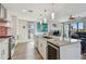 Open kitchen with stainless steel appliances, center island with seating, and modern finishes at 199 Dali Blvd # 607, St Petersburg, FL 33701