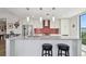 Stylish kitchen features a center island, sleek cabinetry, and a vibrant tile backsplash at 199 Dali Blvd # 607, St Petersburg, FL 33701