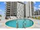 Rooftop pool with comfortable lounge chairs overlooking the city skyline, perfect for relaxation at 199 Dali Blvd # 607, St Petersburg, FL 33701
