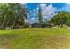 Expansive backyard with lush green lawn and mature trees at 2010 4Th W Ave, Palmetto, FL 34221