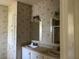 Bathroom showcasing a dual sink vanity, vintage wallpaper, and a mirrored medicine cabinet at 205 Portia S St, Nokomis, FL 34275