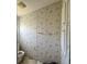 Modest bathroom with built-in storage and patterned wallpaper at 205 Portia S St, Nokomis, FL 34275