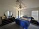 Bright bedroom featuring a ceiling fan, a window with blinds, and a dark wood dresser set at 205 Portia S St, Nokomis, FL 34275