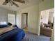 Bedroom featuring a double bed with blue comforter and view to an adjacent sitting area at 205 Portia S St, Nokomis, FL 34275