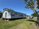 Single story home with a boat in the driveway and a well-maintained lawn at 205 Portia S St, Nokomis, FL 34275