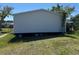 Exterior view of the back of the home with stairs and green lawn at 205 Portia S St, Nokomis, FL 34275