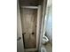Shower with an aging glass door, and a stained toilet in a small bathroom at 205 Portia S St, Nokomis, FL 34275