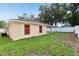 Spacious backyard with ample lawn space, enhanced by a secure privacy fence at 212 W Humphrey St, Tampa, FL 33604