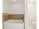 Bathroom with a tiled bathtub and commode at 212 W Humphrey St, Tampa, FL 33604