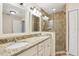 Bathroom with double vanity, granite countertops and tiled walk-in shower at 212 W Humphrey St, Tampa, FL 33604