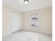 This empty bedroom features a double-door closet, a window with security bars and tile flooring at 212 W Humphrey St, Tampa, FL 33604