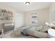 Virtually staged bedroom features a modern bed, stylish decor, and tile flooring for a comfortable living space at 212 W Humphrey St, Tampa, FL 33604