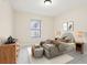 Staged bedroom features a large bed, dresser, and decor at 212 W Humphrey St, Tampa, FL 33604