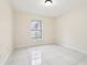 The bedroom features a window and tile floors at 212 W Humphrey St, Tampa, FL 33604