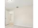 Empty bedroom with neutral walls, tile flooring, and an open doorway to other rooms in the home at 212 W Humphrey St, Tampa, FL 33604