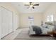 Staged bedroom features a ceiling fan, a window, three closets and tile floors at 212 W Humphrey St, Tampa, FL 33604