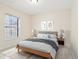 Virtually staged bedroom features neutral walls, modern bed, stylish decor, and tile flooring at 212 W Humphrey St, Tampa, FL 33604