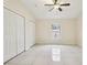 Spacious bedroom with tile flooring, ceiling fan, and a large window at 212 W Humphrey St, Tampa, FL 33604