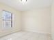 This empty bedroom features a double-door closet, a window with security bars and tile flooring at 212 W Humphrey St, Tampa, FL 33604