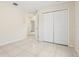 Bright bedroom featuring tile flooring, a double-door closet, and a doorway that leads to other rooms in the home at 212 W Humphrey St, Tampa, FL 33604