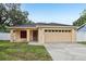 Charming single-story home featuring a spacious two-car garage and well-maintained lawn at 212 W Humphrey St, Tampa, FL 33604