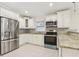 Modern kitchen equipped with stainless steel appliances, granite countertops, and ample cabinetry at 212 W Humphrey St, Tampa, FL 33604